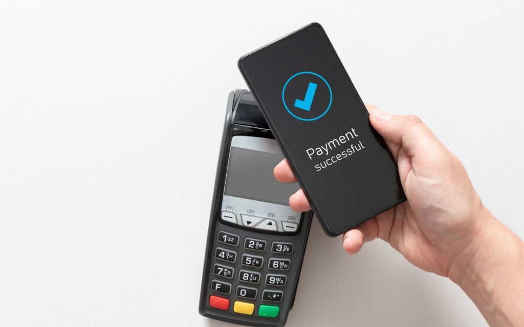 Contactless mobile payment being processed at card terminal showing convenient payment methods at Manassra Dental San Jose