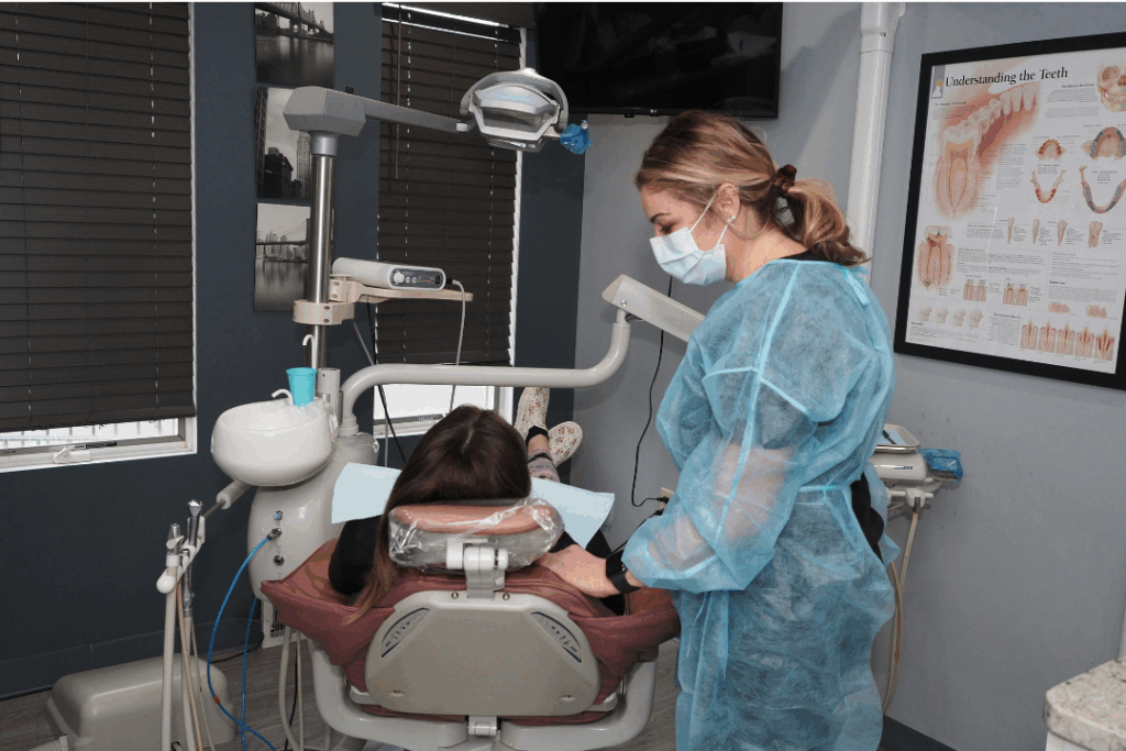 Dental professional in protective gear attending to a patient in a modern dental operatory, symbolizing Manassra Dental in San Jose as a trusted **partner in preventive oral health**.