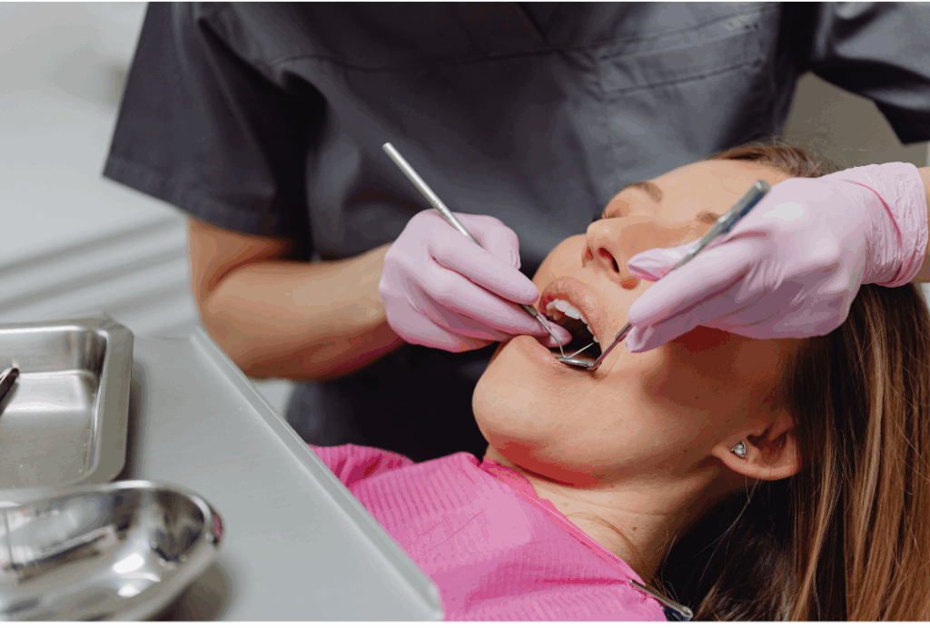 Dental professional placing a custom-made restoration onto a tooth model, illustrating the precision of **Inlays and Onlays** for **conservative repair of moderate damage** at Manassra Dental in San Jose.