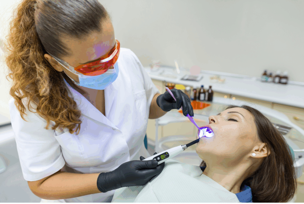 Two dental professionals closely attending to a patient in the dental chair, emphasizing the stringent **safety protocols and professional monitoring** of **Sedation Dentistry** at Manassra Dental in San Jose.