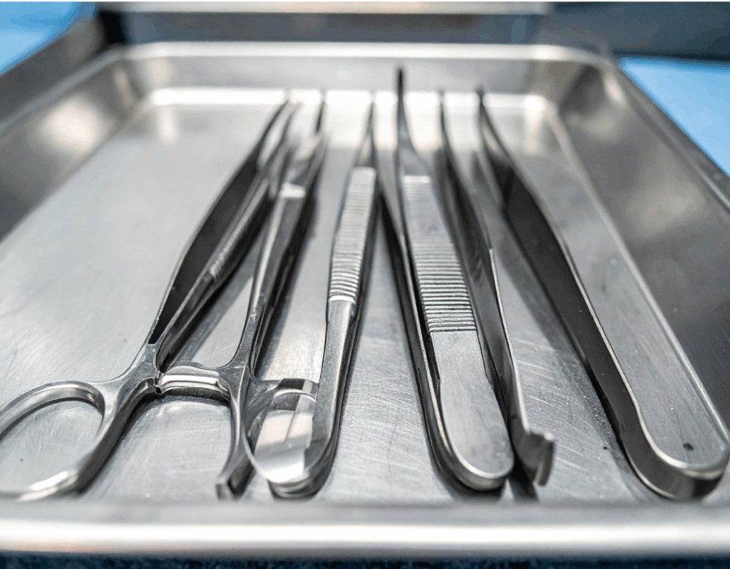 Sterile surgical instruments arranged on a tray, representing the clinical preparation for durable **Stainless Steel Crowns** for children at Manassra Dental in San Jose.