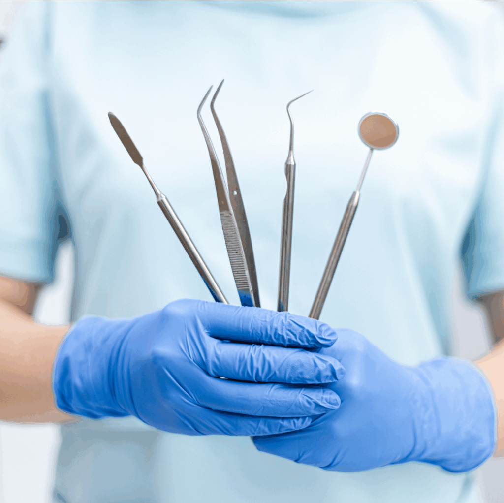 Dental professional in San Jose holding a set of sterile dental instruments at Manassra Dental.