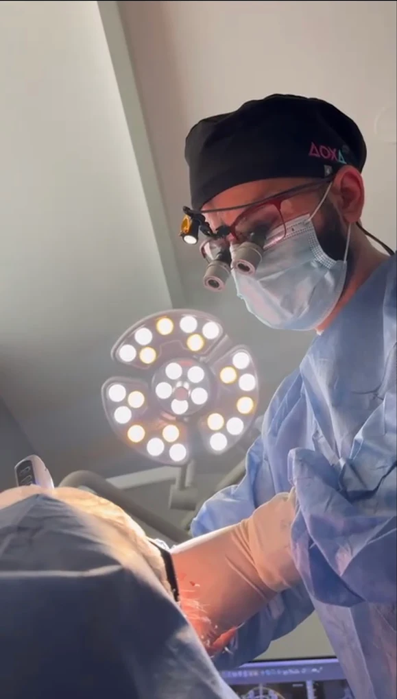 Patient receiving All-on-4 dental implants for full-arch restoration using four implant posts.