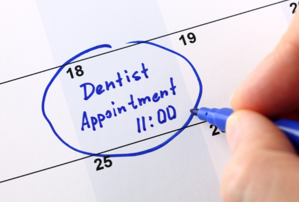 A calendar with "Dentist Appointment" circled in blue, highlighting the importance of scheduling periodic exams every six months.